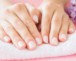 Hands resting on a manicure towel