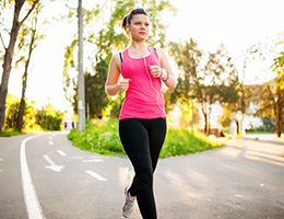 A woman walking briskly down a street.