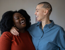  Two women hug and laugh