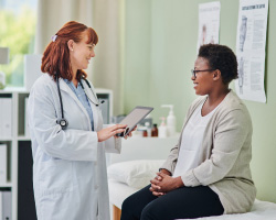 A woman talks with her health care provider during an office visit.