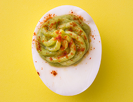 Deviled egg with an avocado filling.
